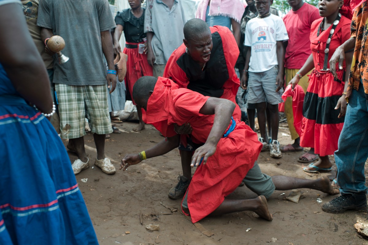 A Vodou houngan performing a sacred ceremony ritual in Haiti
